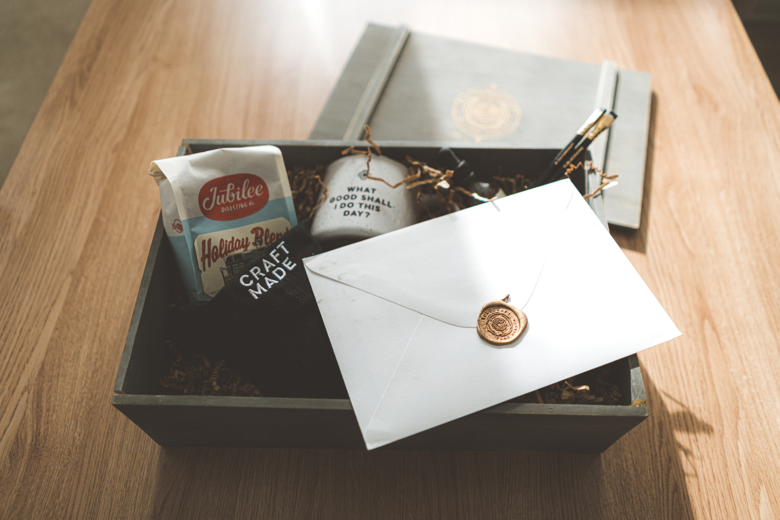 In each custom-made wooden box we included things like coffee from our favorite coffee shop in Denver, craft bitters for use in cocktails, customized Blackwing pencils, and other beautiful items.